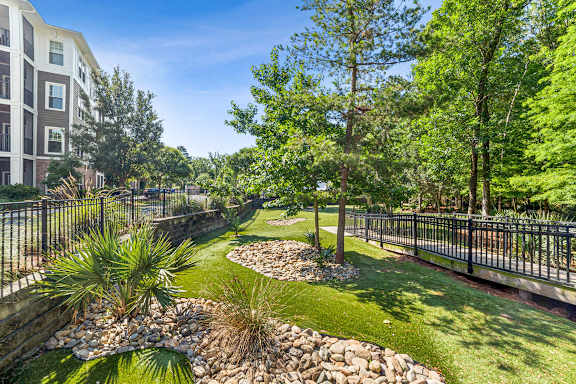 A well-maintained garden with a small stream running through it.