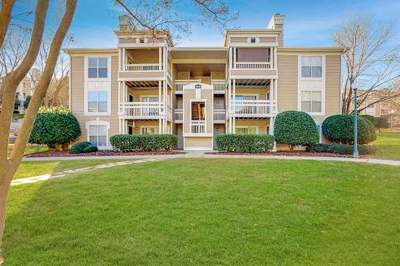 an apartment building with a green lawn and a sidewalk in front of it at Beacon Ridge Apartments, Greenville, SC, 29615