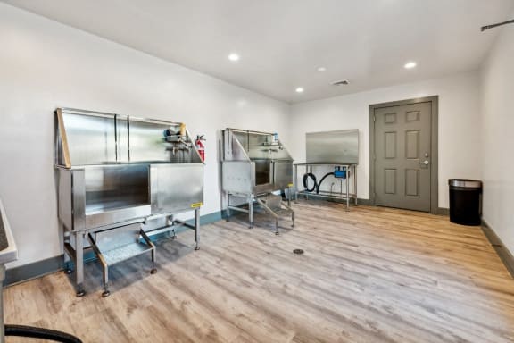 a tasting room with three refrigerators and a door at The Courtyards of Chanticleer, Virginia Beach, VA