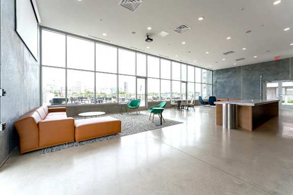 a large lobby with couches and chairs and a table at South Falls Tower, Richmond, VA, 23224