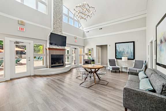A living room with a grey couch and a wooden table.