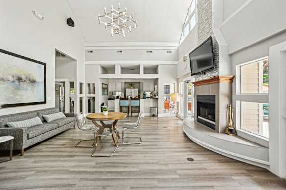 A modern living room with a wooden floor and a fireplace.