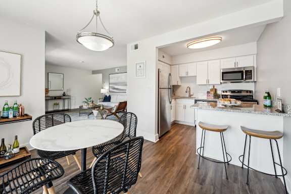 A modern kitchen with a dining table and chairs.