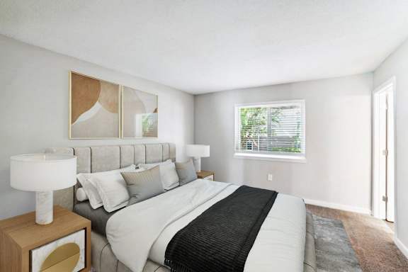 a bedroom with a large bed and a window at Lakecrest Apartments, PRG Real Estate Management, Greenville, South Carolina