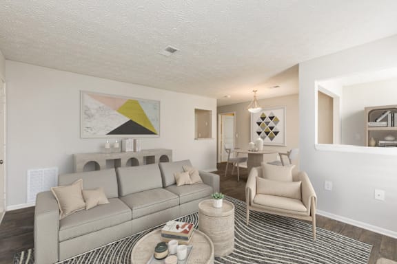 a living room and dining room with a couch and chairs and a table at Edgemont Apartments, PRG Real Estate, Greenville, 29615