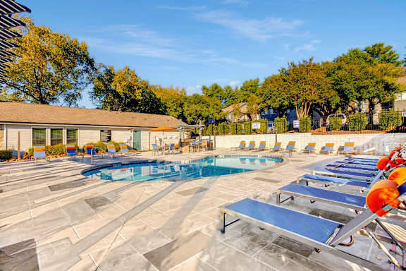 our resort style swimming pool is filled with lounge chairs and umbrellas at Edgemont Apartments, PRG Real Estate, Greenville, 29615