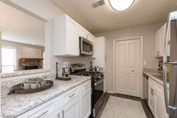 a kitchen with white cabinets and granite counter tops at Edgemont Apartments, PRG Real Estate, Greenville, 29615