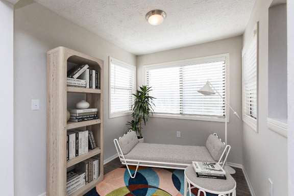 a living room with a couch and a table and a window at Edgemont Apartments, PRG Real Estate, Greenville, 29615