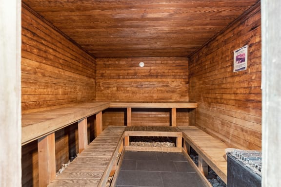 an empty sauna with wooden benches
