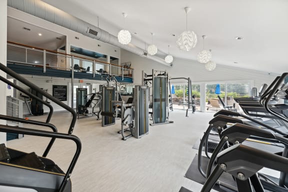 a gym with treadmills and other exercise equipment