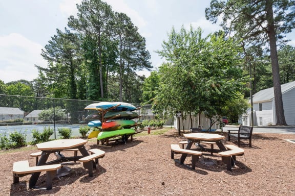 our apartments have a community picnic area with tables and chairs at Lake Johnson Mews, North Carolina