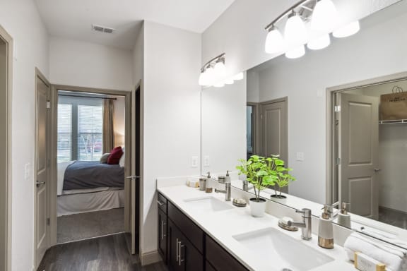a bathroom with two sinks and a large mirror