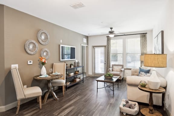 our apartments offer a living room with a couch a chair and a coffee table