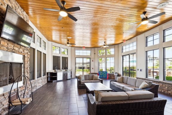 a large living room with a fireplace and a large screen tv on the wall