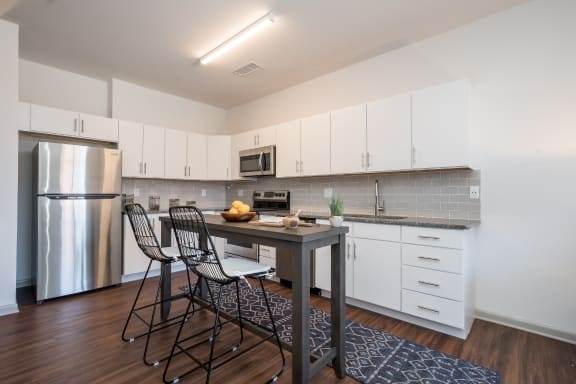a kitchen with white cabinetry and stainless steel appliances at East 51 At Rocketts Landing, Richmond, 23231
