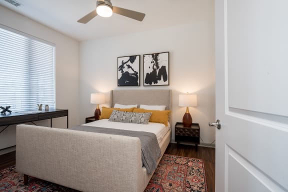 a bedroom with a bed and a desk at East 51 At Rocketts Landing, Richmond, 23231