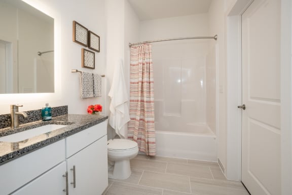 a bathroom with a shower toilet and sink at East 51 At Rocketts Landing, Richmond, 23231
