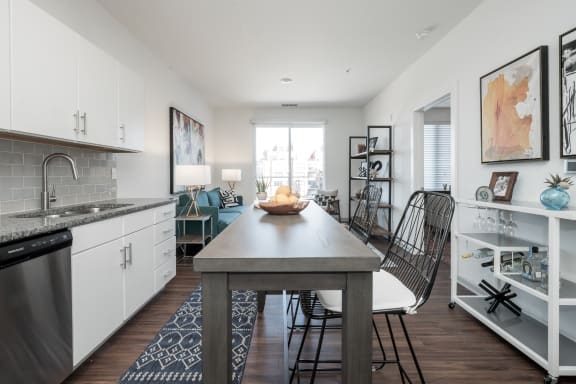 a kitchen and living room with white walls and wood flooring at East 51 At Rocketts Landing, Richmond, 23231