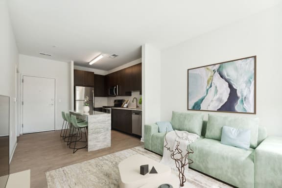 a living room with a green couch at The Box, Richmond, VA, 23224