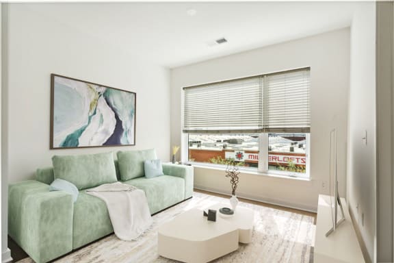 a living room with a green couch at The Box, Richmond, VA, 23224