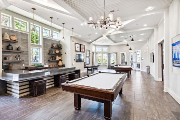 a recreation room with a pool table and a bar