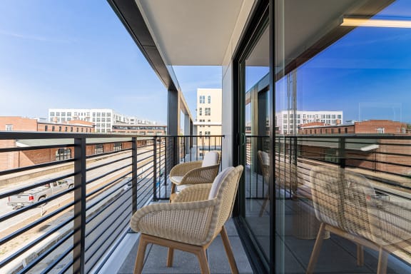 a balcony with chairs and a table at The Box, Richmond, VA, 23224