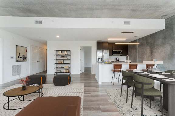 a living room and kitchen with a table and chairs at South Falls Tower, Richmond, VA, 23224