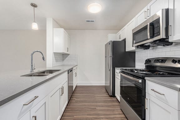 Two bedroom kitchen with white shaker style cabinetry at Eagle Ridge Apartment Homes, Traverse City, 49685