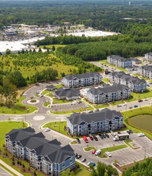 A large apartment complex with a roundabout in front of it.