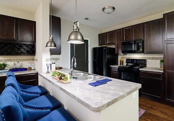 a kitchen with black appliances and a white counter top
