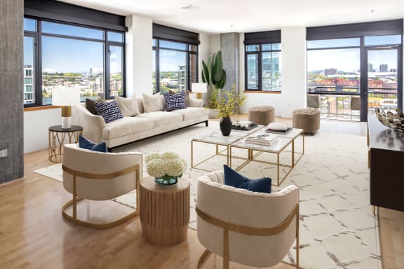 a living room with white couches and chairs and a table