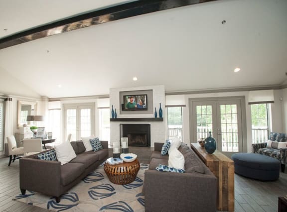 a large living room with a couch and a fireplace at SoCO Apartments at Vinings, Smyrna, 30080
