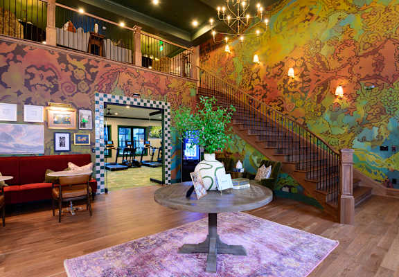 A living room with a staircase and a couch.