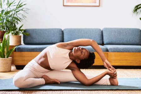 a woman doing yoga on a yoga mat in a living room