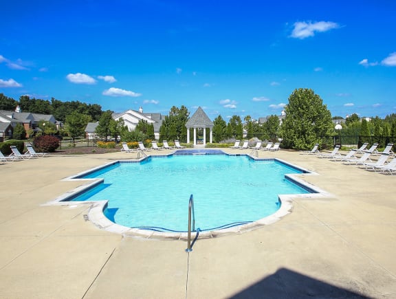 Large Outdoor Pool with Expansive Sundeck and Lounge Furniture