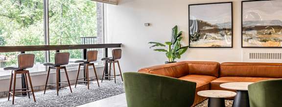 A modern dining room with a wooden table and chairs.