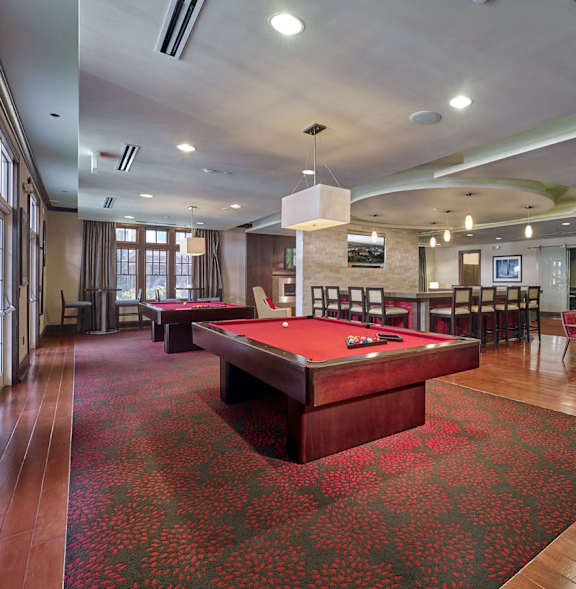 A room with a pool table and a red carpet. at Vermella Lyndhurst apartments, Lyndhurst, NJ, 07071