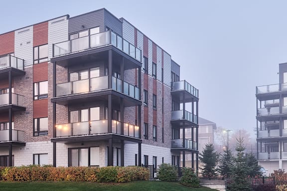 A modern apartment building with balconies and multiple stories.