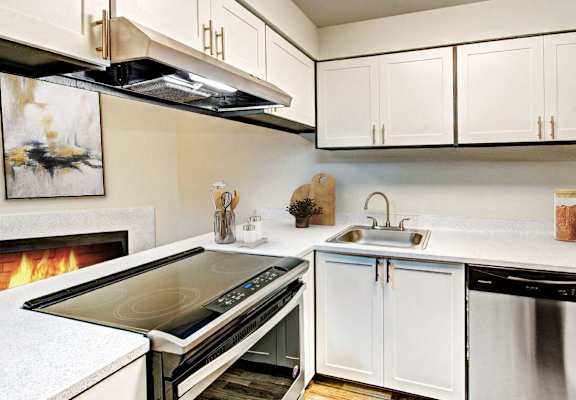 a kitchen with a stove top oven and a sink at Autumn Village, Milton, WA, 98354