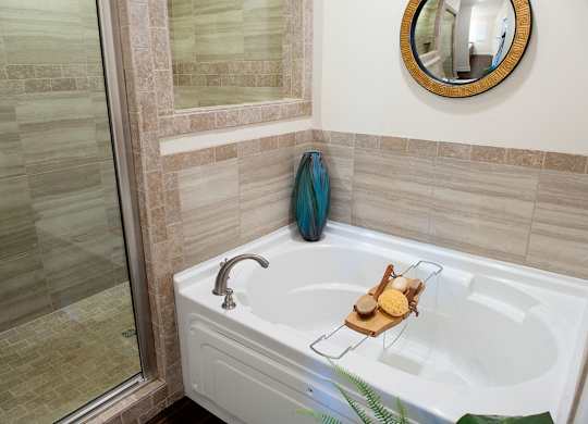A bathroom with a white tub and a blue towel.