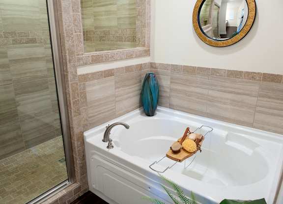 A bathroom with a white tub and a blue towel.