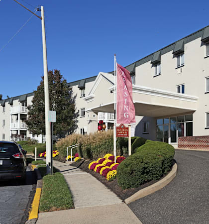 an apartment building with a pink flag in front of it