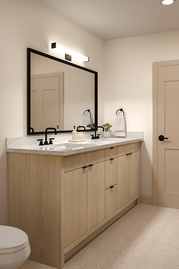 A bathroom with a sink, mirror, and toilet.