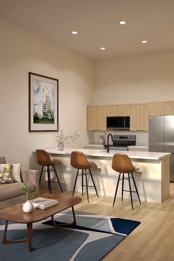 A modern kitchen with a bar stool and a framed picture on the wall.