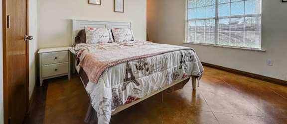 a bedroom with a bed and a ceiling fan