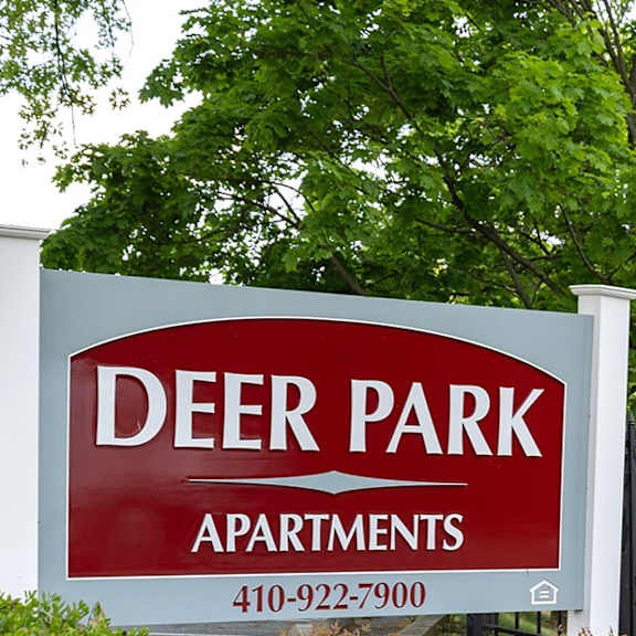 a kitchen with white appliances and wooden cabinets at Deer Park Apartments, Randallstown, 21133