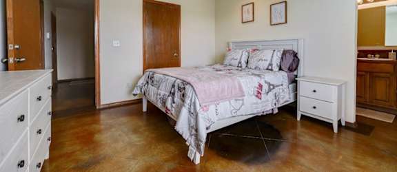 a bedroom with a bed and a ceiling fan