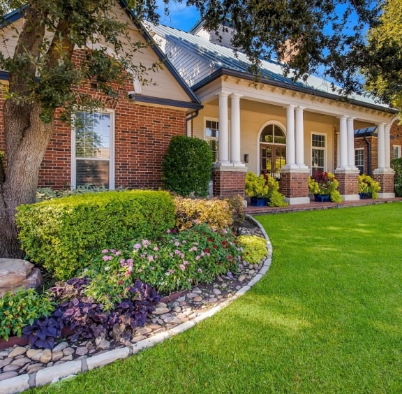 a house with a lawn and a tree in front of it