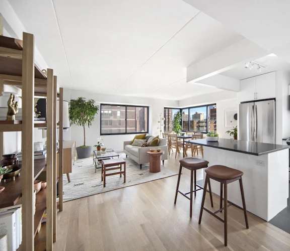 A modern kitchen with a bar stool and a countertop.