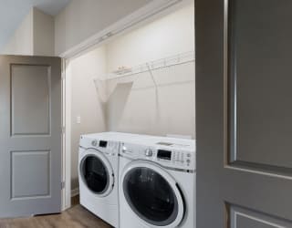 A washer and dryer are included in the 2 bedroom Marigold with den floor plan at WH Flats